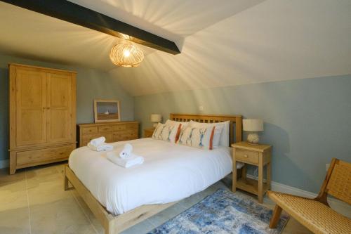 Katil atau katil-katil dalam bilik di Boat Shelter Cottage