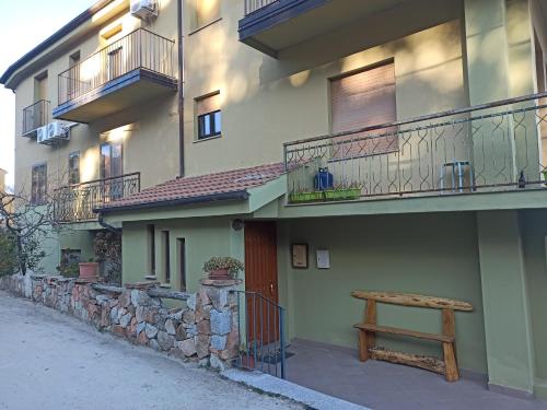 a bench sitting on the side of a building at La Finestra Sul Mare in Lanusei