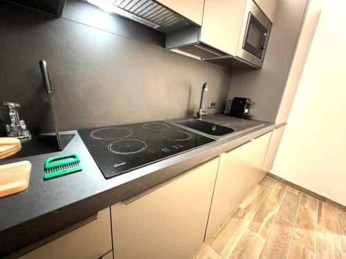 a kitchen with a stove and a counter top at Suite Arnaldo 10 - Sanremo in Sanremo