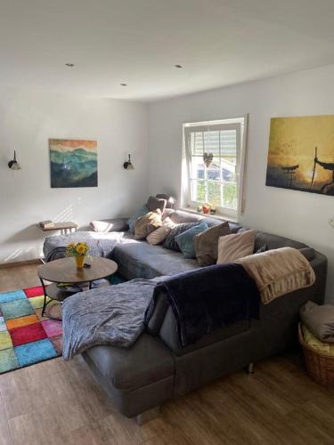 a living room with a couch and a table at Ferienhaus Glückspilz beim Hennesee in Meschede