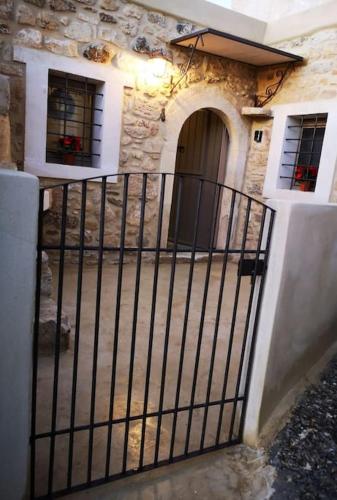 a gate in front of a house with a door at Casa Opuntia in Pappayiannádhes