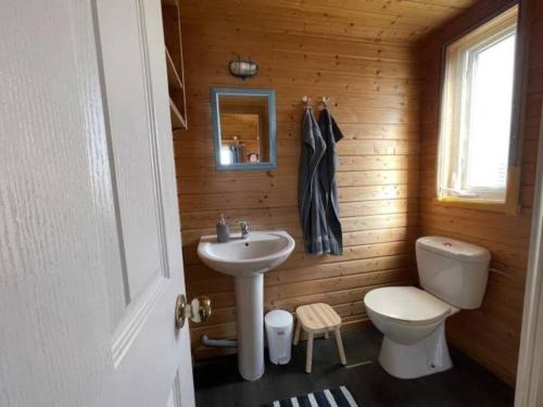 a bathroom with a white sink and a toilet at Da Silva Surfcamp - Tiny House Jorgina in Lourinhã