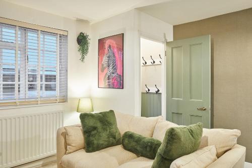 a living room with a white couch with green pillows at Host & Stay - Bentley Wynd in Yarm