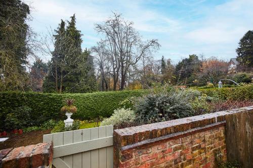 a garden with a brick wall and a fence at Host & Stay - Bentley Wynd in Yarm
