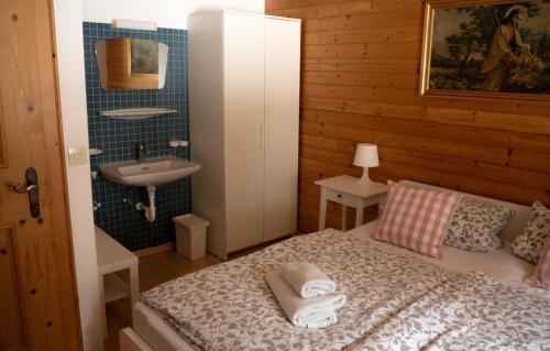 a small bedroom with a bed and a sink at Ferienhaus am Gebraweg in Fieberbrunn in Tirol - Saalbach, Leogang, Hochfilzen, Kitzbühel in Fieberbrunn