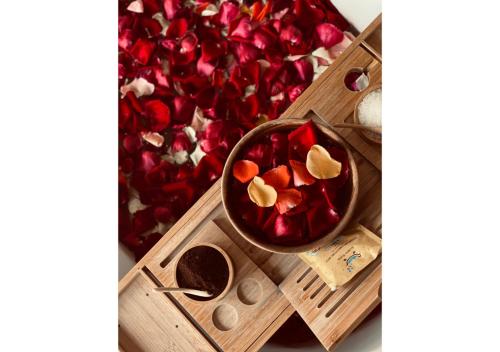 a bowl of red peppers on a wooden tray at Wild Cottages Elephant Sanctuary Resort in Amphoe Koh Samui