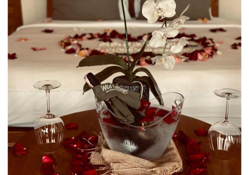 a vase with a plant in it on a table at Wild Cottages Elephant Sanctuary Resort in Amphoe Koh Samui