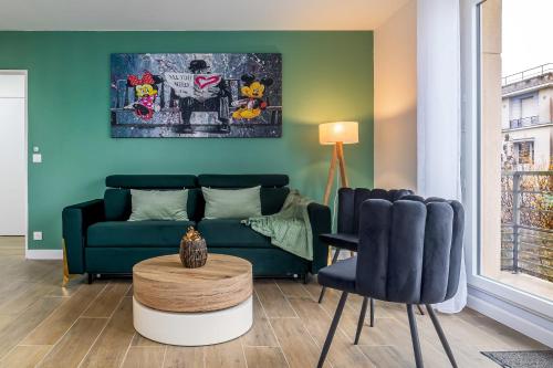 a living room with a couch and a table and chairs at Lémeraude Magic Dreams Near Disneyland in Montévrain