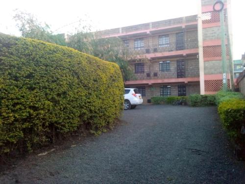 a white car parked in front of a building at Sifa Stays in Ongata Rongai 