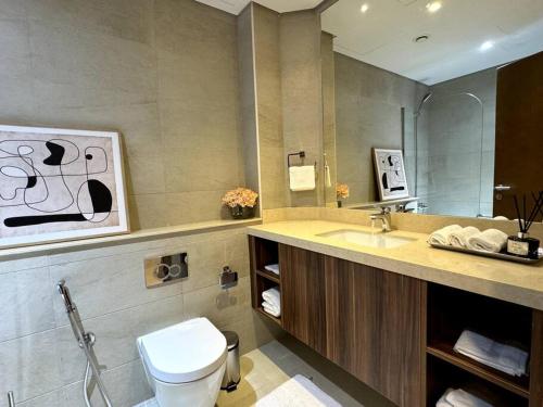a bathroom with a sink and a toilet in it at Luxury Apartment Mina Azizi Palm Jumeirah-Private Beach in Dubai