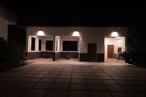 a night view of a house with lights on it at Softouch Ayurveda Village Kerala in Kizhake Chālakudi