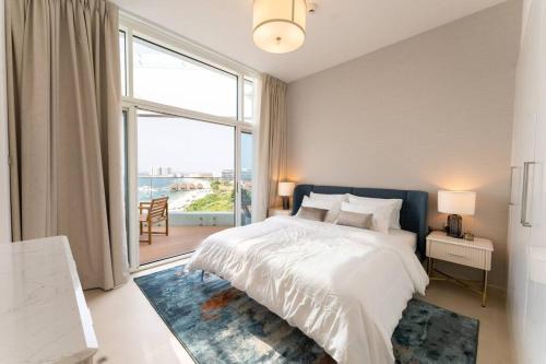 a bedroom with a large bed and a large window at Luxury Apartment Mina Azizi Palm Jumeirah-Private Beach in Dubai