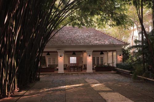 a small house with a pavilion in a garden at Softouch Ayurveda Village Kerala in Kizhake Chālakudi