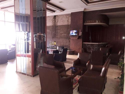 a salon with chairs and a waiting room with a mirror at YILDIZ HOTEL in Altındağ