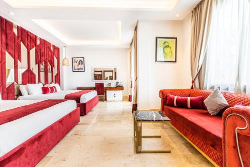 a hotel room with two beds and a couch at One Hotel Casablanca in Casablanca