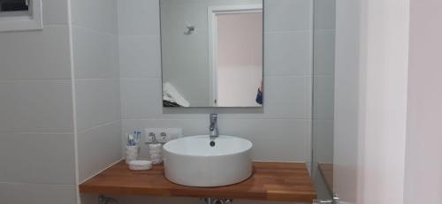 a white bathroom with a sink and a mirror at Apartamento en Son Bou cerca de la playa in Son Bou