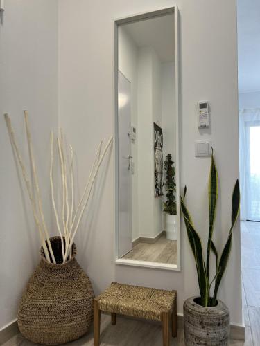 a bathroom with a mirror and a bench and a stool at 5th Element Espartal by Lisbeyond in Aljezur
