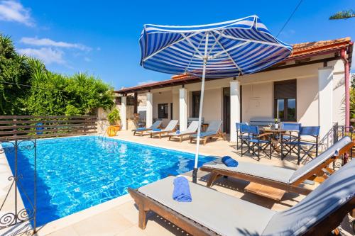 a villa with a swimming pool and an umbrella at Villa Maro Large Private Pool AC WiFi in Kefalás