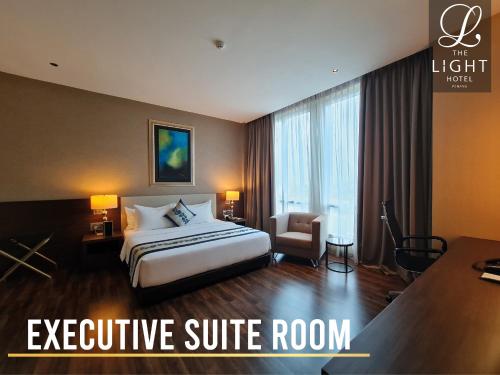an executive suite room with a bed and a desk at The Light Hotel Penang in Perai