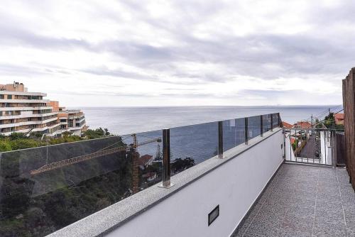 a balcony with a view of the ocean at Casa do Sol in Funchal
