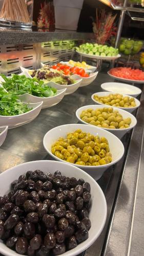 a buffet filled with bowls of olives and vegetables at Hilton Garden Inn Corlu in Corlu