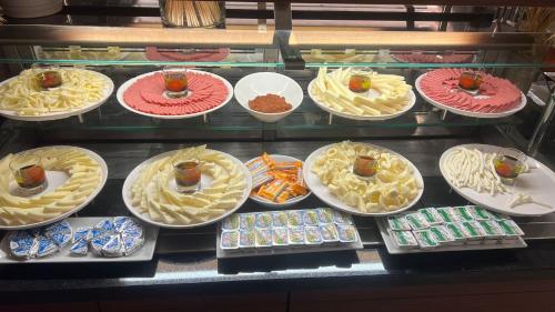 a display case filled with lots of plates of food at Hilton Garden Inn Corlu in Corlu