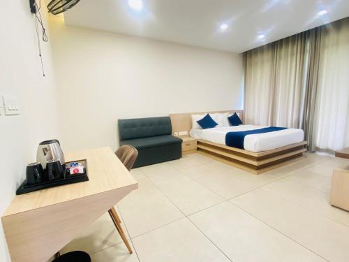 ein Hotelzimmer mit einem Bett und einem Sofa in der Unterkunft Mount view by farstay in Wayanad