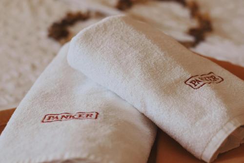 a white towel with the word danger written on it at Rooms and Apartments Panker in Moravske-Toplice