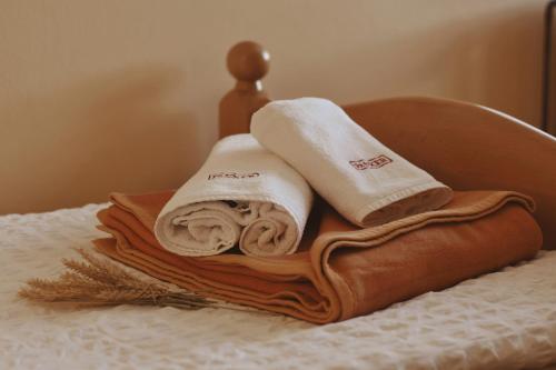 a pile of towels sitting on top of a bed at Rooms and Apartments Panker in Moravske Toplice