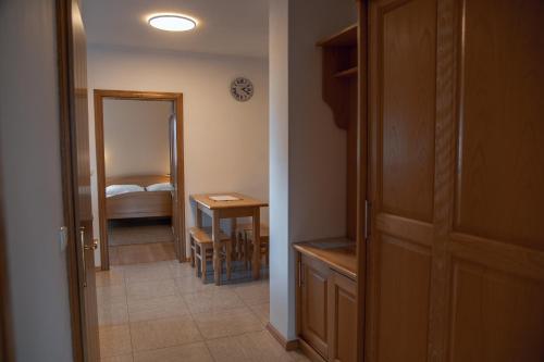 a hallway with a room with a bed and a table at Rooms and Apartments Panker in Moravske Toplice
