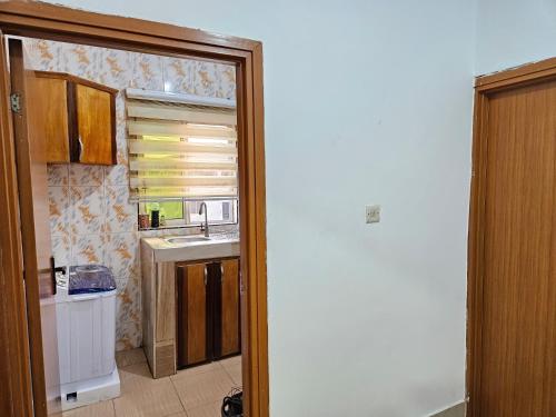 a kitchen with a sink and a microwave at Private-room with washroom in spintex, Accra in Accra