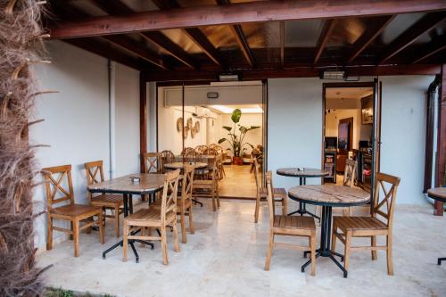 a group of tables and chairs in a restaurant at VillaQua Boutique Hotel in Sile