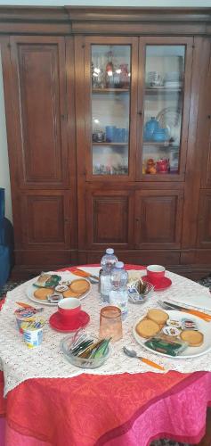 a table with plates of food on top of it at Il Centrale Guest House in Nuoro