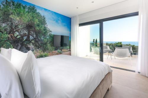 a bedroom with a white bed and a large window at Luxury Villa 360 - private heated pool in Novalja