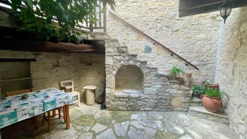 a stone building with a stone oven in a yard at Juliet Suite by TrulyCyprus in Doros