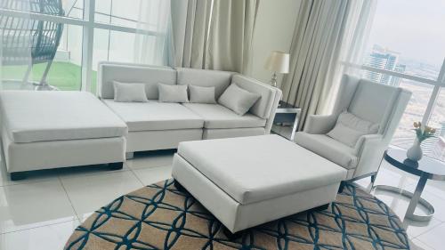 a living room with a couch and two chairs at Walking distance to dubai mall Full burj Khalifa view and fountain view new year full fireworks view 2BR in Dubai