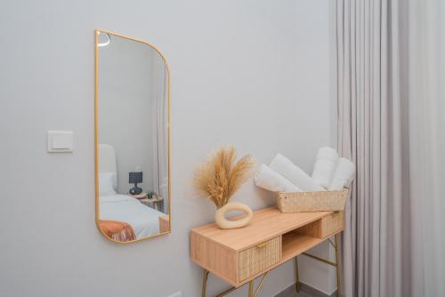 a bathroom with a mirror and a wooden shelf with towels at Tamm - Mesk 1 Tower in Dubai