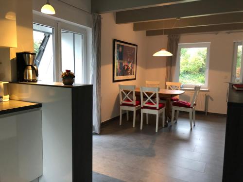 a kitchen and dining room with a table and chairs at Schlei 48 in Borgwedel