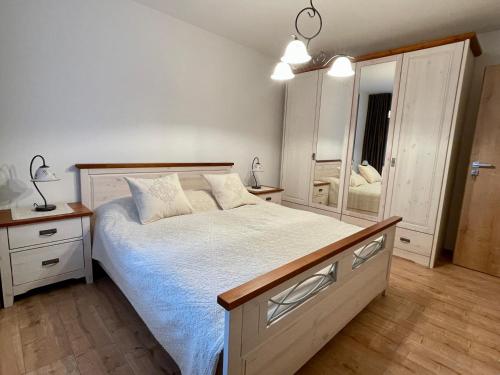 a bedroom with a bed and a large mirror at Apartmány Kľak in Kľačno