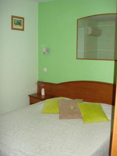 a bedroom with a bed with a mirror on it at Chambres d'hôtes la Chaumière in Arcy-sur-Cure
