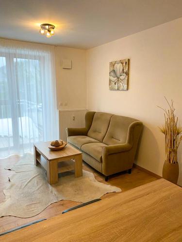 a living room with a couch and a coffee table at Apartmány Kľak in Kľačno