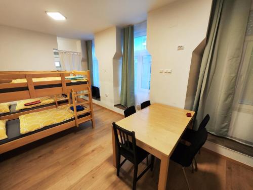 a room with a table and a bed and a table and chairs at Cosy Family Condo // Double Deck in Vienna