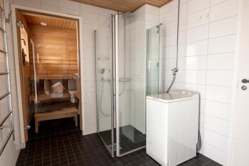 a bathroom with a shower stall and a toilet at 2ndhomes Gorgeous and Unique Top Floor Apartment with Sea Views and Sauna in Helsinki