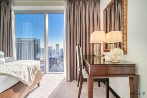 um quarto com uma secretária, uma cama e uma janela em Flawless 2BR at The Address Residences Dubai Marina by Deluxe Holiday Homes em Dubai