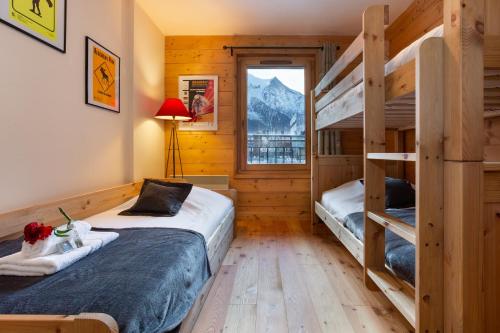 een slaapkamer met 2 stapelbedden en een raam bij Appartement Belle Vue - Happy Rentals in Chamonix-Mont-Blanc