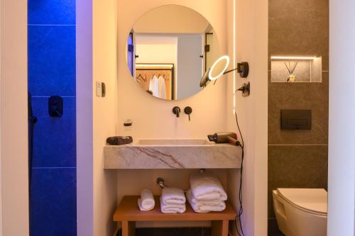 a bathroom with a sink and a mirror at Skia, Premium Key Collection in Skiathos