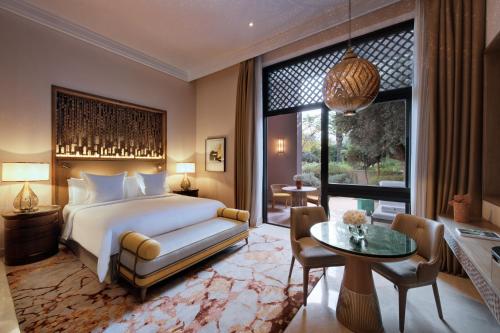 a bedroom with a bed and a large window at Four Seasons Resort Marrakech in Marrakesh