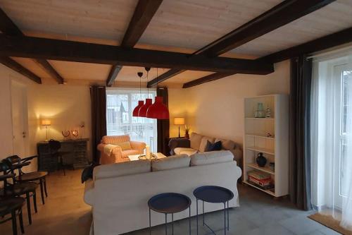 a living room with a white couch and some chairs at Centralt by hus Blokhus-Hune til 10 pers privat Gårdhave in Blokhus