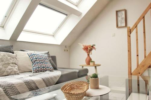 a living room with a couch and a window at Un cocon au bord de l'eau in Binic-Etables-sur-Mer