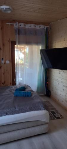 a bedroom with a bed in a wooden room at Onix- Kis-tó Apartman ORFŰ in Orfű